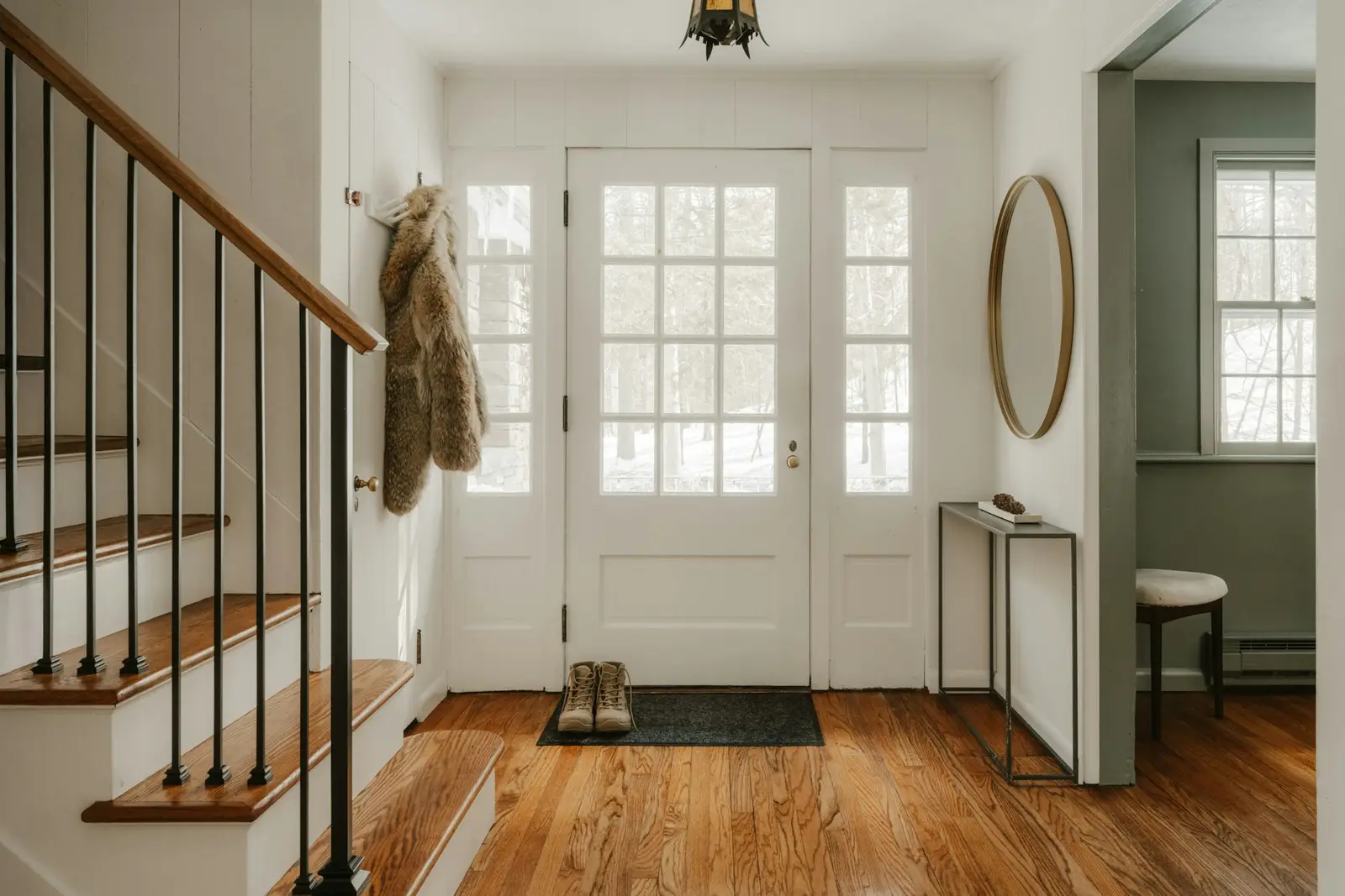 Calm home entryway with a bench and coat hooks